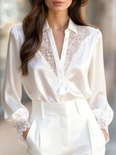 White satin button up shirt with lace trim satin detailing along the neckline and cuffs