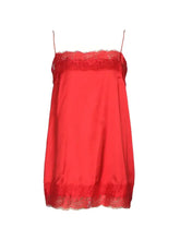 A vibrant red lace trimmed satin camisole with delicate lace trim along the neckline and hem