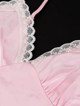 Delicate pink lace trimmed satin camisole top with intricate white lace trim along neckline and straps