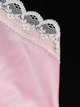 Pink lace trimmed satin cami featuring delicate white lace trim along the edge of the satin fabric