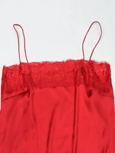 A vibrant red lace trimmed satin cami featuring delicate lace along the neckline and thin spaghetti straps