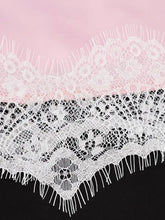 White lace trimmed satin cami featuring intricate floral lace trim and delicate fringes on the edges
