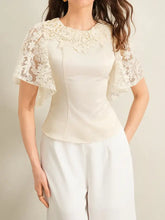 Cream-colored lace trimmed short sleeve blouse featuring delicate floral lace detailing on shoulders with flutter sleeves