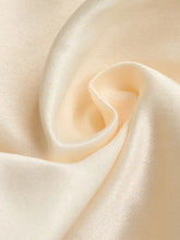 Cream-colored satin lace trimmed short sleeve blouse with smooth glossy texture and subtle sheen fabric