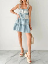 Light blue denim mini dress with white lace trim and button details featuring a tiered design denim mini dress