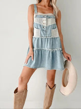 Light blue denim mini dress with white lace trim and button accents featuring tiered design
