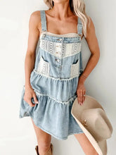 Light-wash denim mini dress with lace trim and button details in a tiered design for casual wear