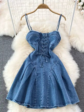 Blue denim corset-style a-line mini dress with thin straps and lace-up front detailing perfect for casual wear