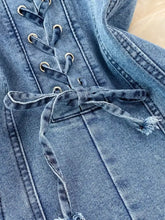 Blue denim a-line mini dress with lace-up front and frayed cord ties in a stylish denim dress design