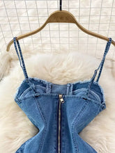 Blue denim corset top with frayed edges and central zipper featured in lace-up denim a-line mini dress