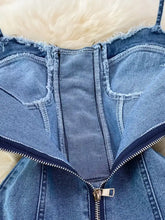 Blue denim corset-style top with frayed edges and central zipper as part of a lace-up denim a-line mini dress