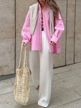 Beige woven tote bag with textured open-knit pattern and sturdy handles styled with lace-up front oversized shirt