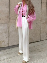Pink lace-up front oversized shirt with relaxed fit and long sleeves made of lace fabric for stylish wear