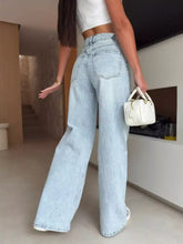 Light-wash denim lace-up high-waisted wide leg jeans shown from the back with classic pockets and wide leg design