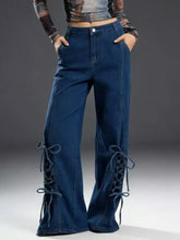 Dark blue denim wide leg jeans with lace-up detailing on the lower legs for a stylish flare look