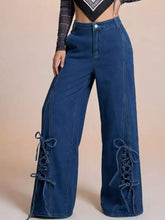 Blue denim wide leg jeans featuring lace up detailing on the sides for a stylish and comfortable look