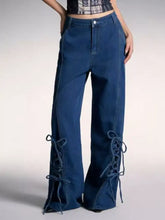 Dark blue denim wide leg jeans featuring lace-up detailing on the lower legs for a stylish look