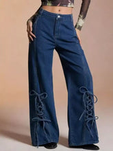 Dark blue denim wide leg jeans with lace-up detailing on the lower legs for a stylish look