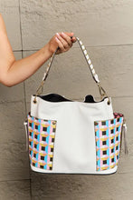 Large white shoulder bag with colorful geometric woven pattern, leather handles, zipper closure