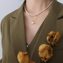 Double-layered freshwater pearl necklace with olive green blazer and dried roses