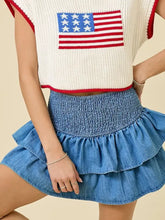 Blue denim skirt with smocked waist and layered ruffle design in a lightweight denim skirt for casual wear