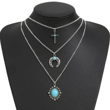 Multi-layered silver necklace with artificial turquoise horseshoe pendant