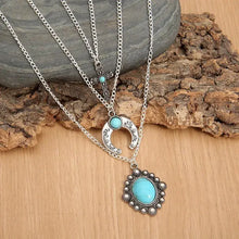 Layered silver necklace with artificial turquoise pendants