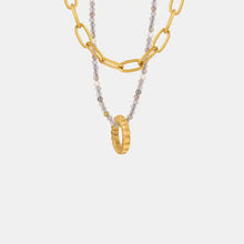 Layered titanium steel necklace with 18k gold-plated chain and beaded ring pendant
