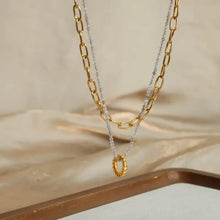 Layered titanium steel necklace with 18k gold-plated chain and beaded ring pendant