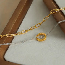 Layered titanium steel necklace with 18k gold-plated chain and beaded pendant