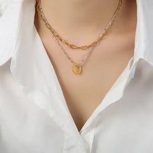Layered titanium steel necklace with 18k gold-plated chain and beaded ring pendant