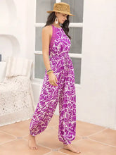 Purple and white leaf print sleeveless jumpsuit with high neckline