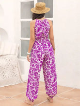 Vibrant purple and white leaf print sleeveless jumpsuit with fitted waistband
