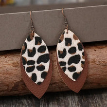 Leaf shape leather dangle earrings in faux leather with brown base, white top, and leopard print