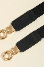 Schwarzer und goldener Ledergürtel mit ineinandergreifender Kreis-Schnalle