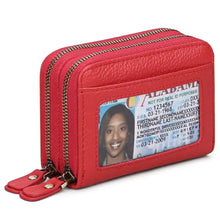 Red leather card case with dual zippers and clear ID window showing Alabama license