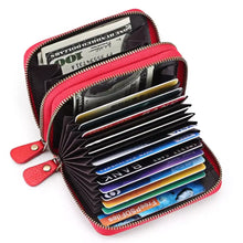 Red leather card case with ID window, dual zippers, and colorful cards