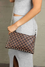 Leather studded shoulder bag with brown checkerboard pattern