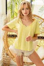 Lemon yellow short sleeve t-shirt with criss-cross V-neck and tie detail