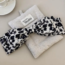 Leopard print bow tie with silver glitter and Studio branding in hair clip set