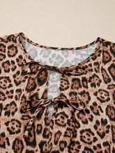 Leopard bow tie puff sleeve blouse with soft flowing fabric and delicate tie details at the neckline