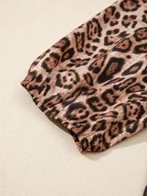 A soft stretchy bow tie puff sleeve blouse with a classic brown and black leopard bow tie print fabric