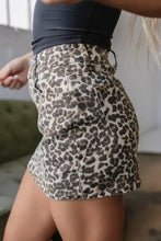 Leopard denim mini skirt with high waist and front pockets in a leopard print denim mini design