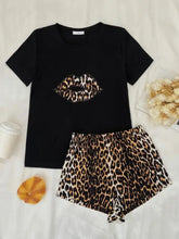 Black t-shirt with leopard print lips graphic and matching leopard print shorts lounge set featuring short sleeve length