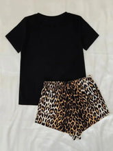 Black short-sleeved top with leopard lip graphic and leopard-print shorts lounge set featuring short sleeve length