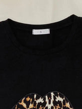 Black leopard lip graphic top with short sleeve length in a lounge set featuring coordinating shorts