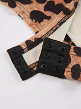 Leopard long sleeve bodysuit with leopard print fabric sleeve black plastic snap fasteners and white inner lining