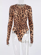A form-fitting leopard long sleeve bodysuit in tan and black featuring a stylish animal print design