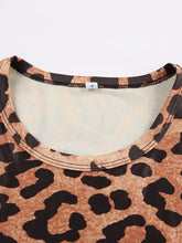 Women’s leopard long sleeve bodysuit with leopard print fabric, round neckline, and black lace trim detailing