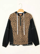 Leopard patchwork contrast stitching quarter zip hoodie in leopard print and black with white drawstrings and slightly stretchy fabric
